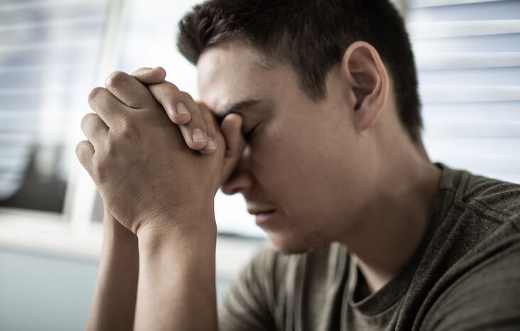 A person with his eyes closed holding his hands together

AI-generated content may be incorrect.
